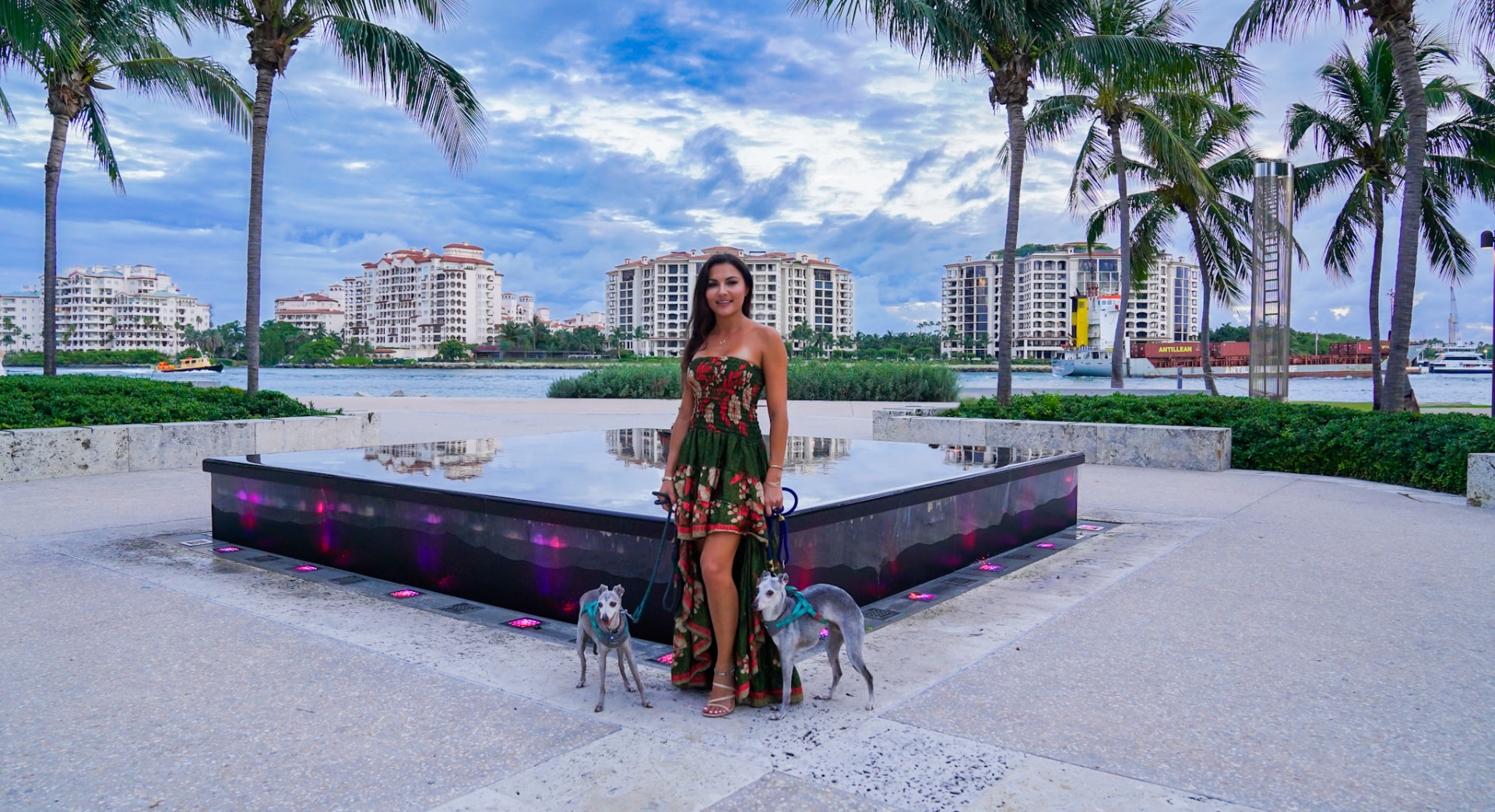 Elmira and her greyhounds beside the reflecting fountain at South Pointe