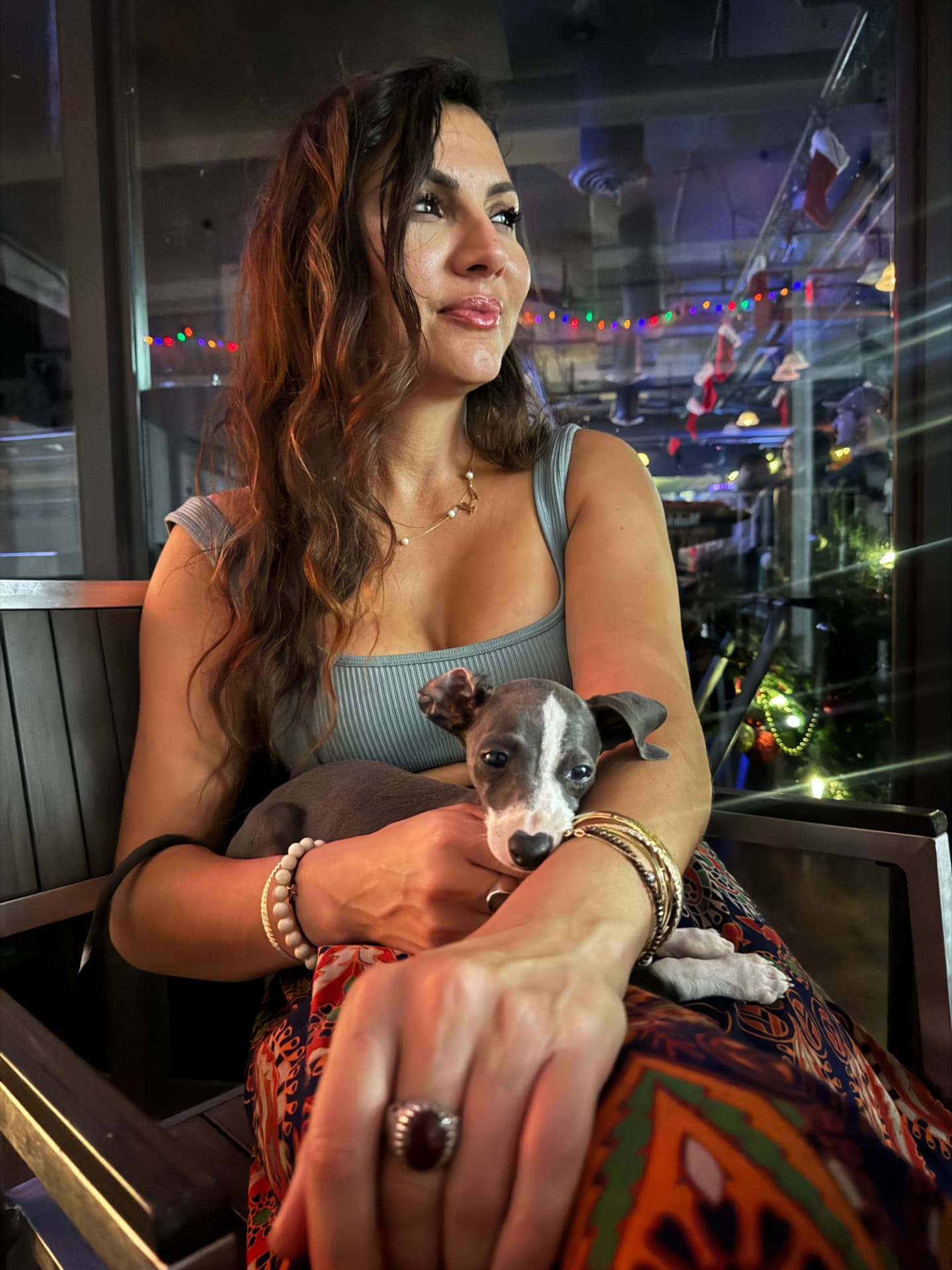 Elmira holding Luna in her lap at dusk